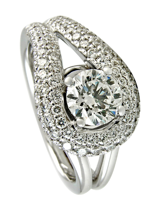 Round brilliant diamond solitaire set in four claws with looping pave band halo